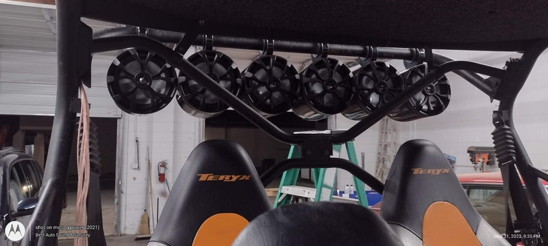 A set of six speaker pods mounted on the overhead bar of a side by side all terrain vehicle