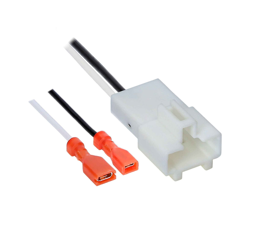 A white plastic multi-pin electrical connector with attached black and white wires, shown alongside two orange-red USB-C connector tips on a plain white background.