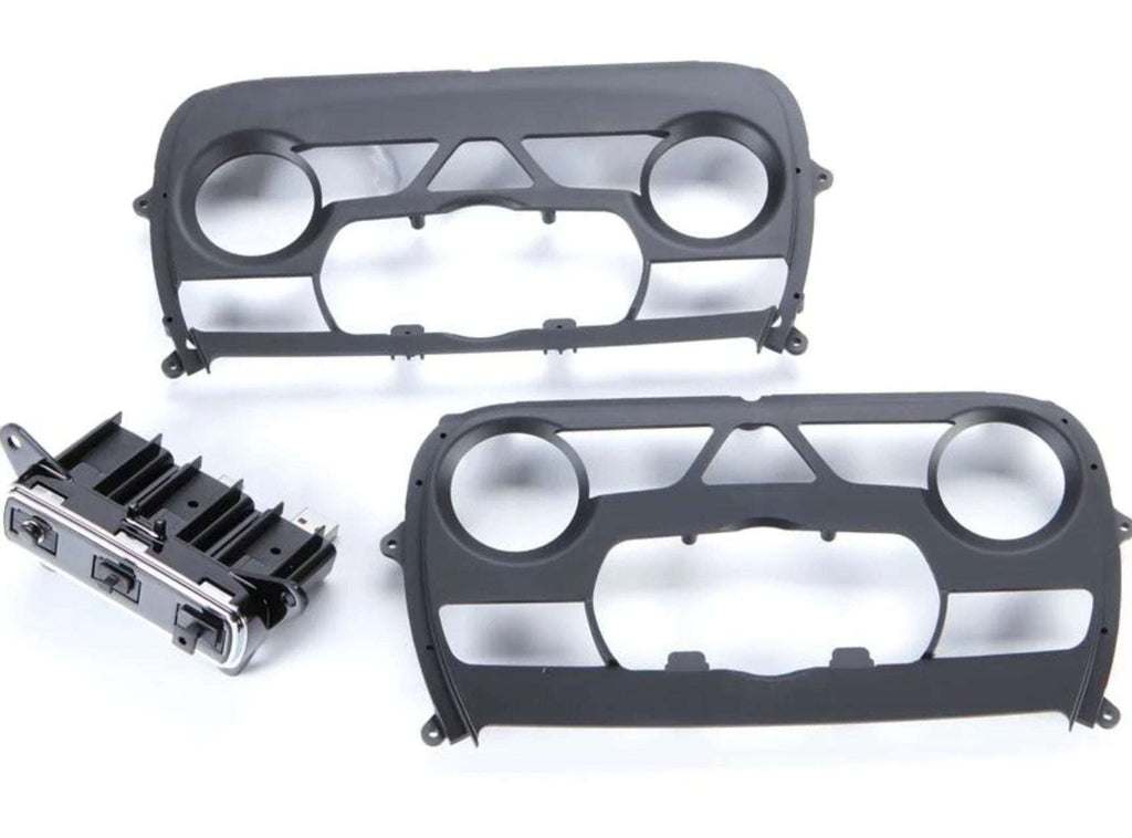 iDatalink KIT-JGC1 included dash kit components showing two gray ABS dash bezels and factory-style HVAC climate control module for Jeep Grand Cherokee