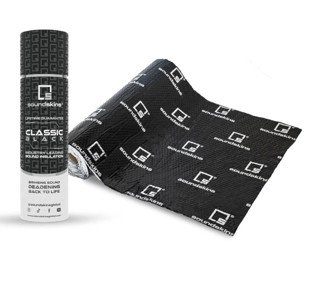 SoundSkins Classic Black sound deadening kit showing cylindrical tube packaging with Classic Black label, Lifetime Guarantee, and Industry Leading Sound Insulation alongside unrolled black butyl deadening sheet with SoundSkins logo pattern
