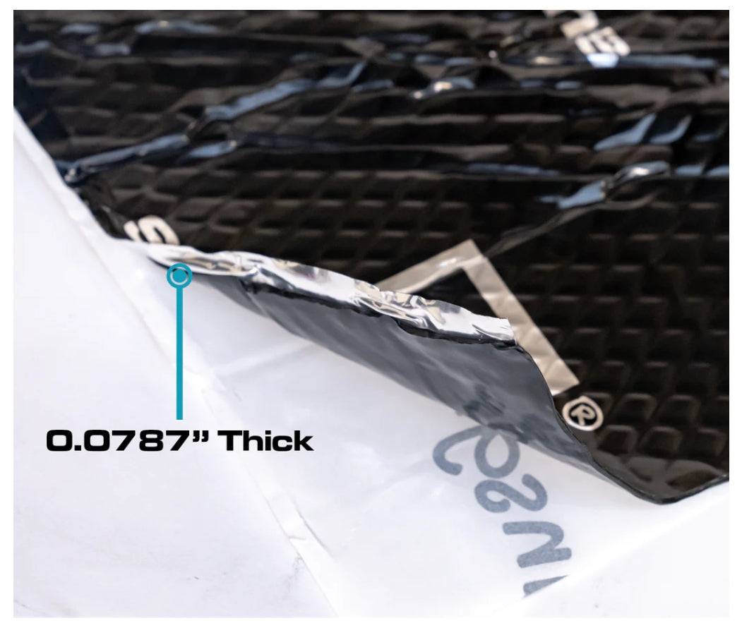 SoundSkins Classic Black sound deadening sheet close-up edge cross-section showing black diamond-embossed butyl top layer, aluminum foil middle layer, and white backing sheet being peeled with 0.0787 inch thickness callout