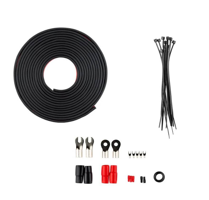 DS18 OFCKIT0 0-gauge OFC amplifier wiring kit hardware accessories flat lay showing black split loom roll, black zip ties, fork terminals, ring terminals, red and black butt connectors, wire connectors, and rubber grommet