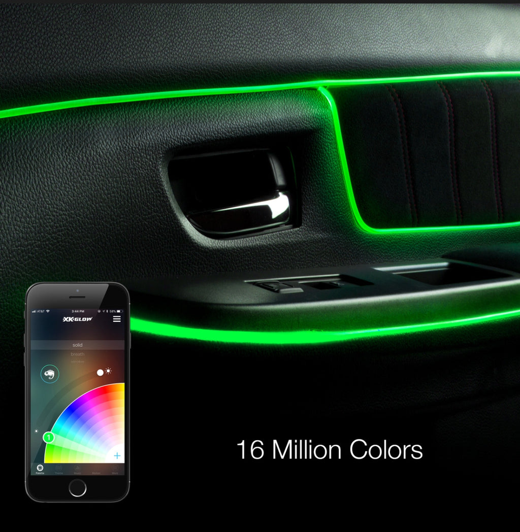 Green LED car door panel ambient light illuminated around the handle and armrests, shown on a black car interior with a smartphone app control overlay and text reading '16 Million Colors'.
