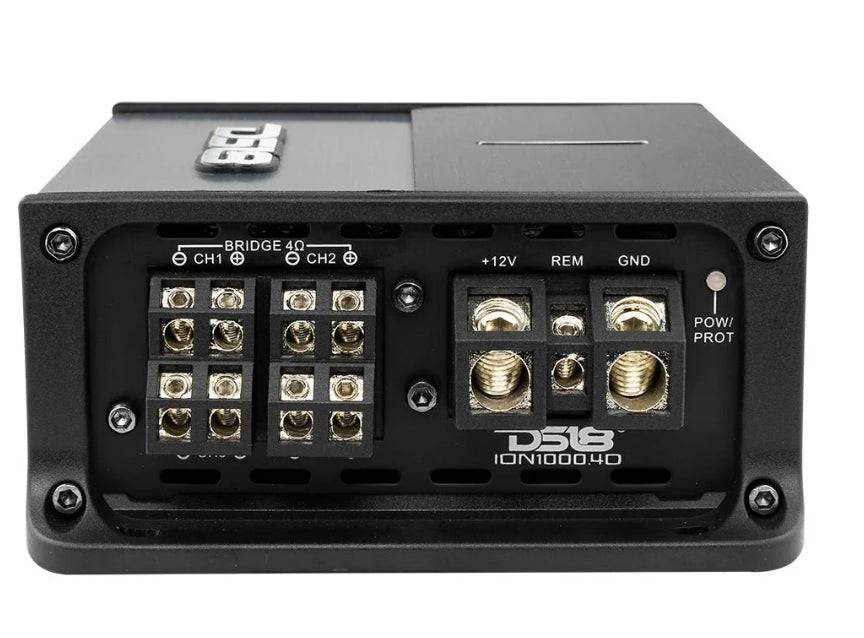DS18 ION1000.4D power and speaker terminal panel showing bridgeable 4 ohm CH1 and CH2 speaker output terminal blocks, plus 12V REM and GND power input screw terminals, power and protection LED indicator, and ION1000.4D model name