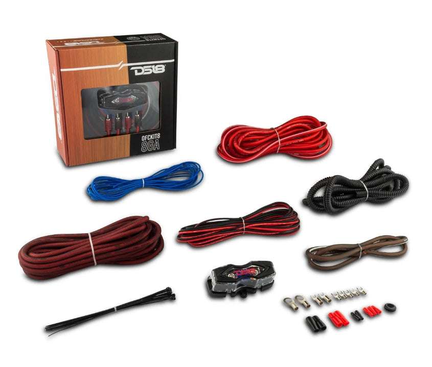 DS18 OFCKIT8 8-gauge OFC amplifier wiring kit complete contents flat lay showing retail box, red OFC power cable with ring terminal, brown OFC ground cable, red, black braided RCA cable, blue remote wire, corrugated loom tube, split loom, DS18 ANL fuse holder, zip ties, ring terminals, fork terminals, butt connectors, and rubber grommet